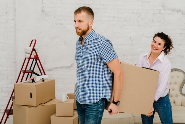 Couple carrying heavy box