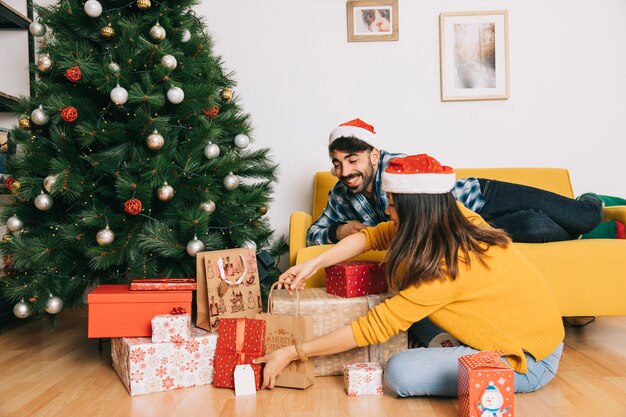 Couple celebrating christmas in living room