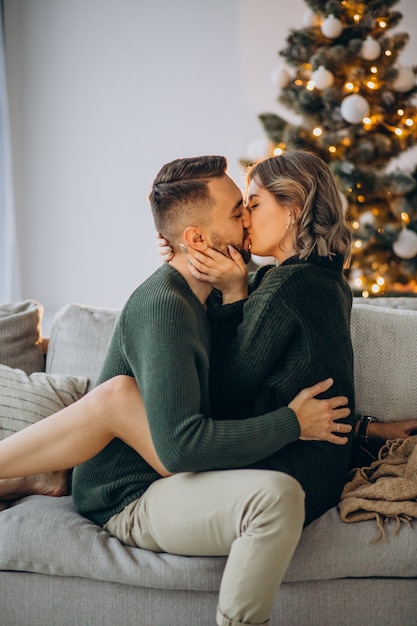 Free photo couple celebrating christmas together at home