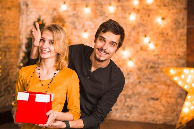 Couple celebrating christmas together with lights