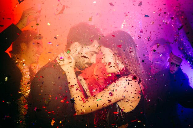 Couple celebrating in club with confetti