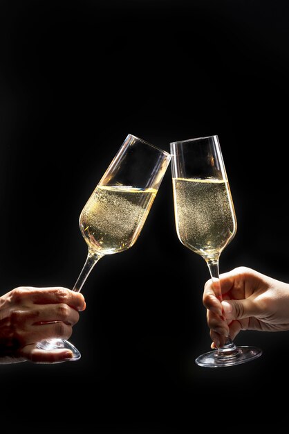 Couple celebrating with champagne on dark