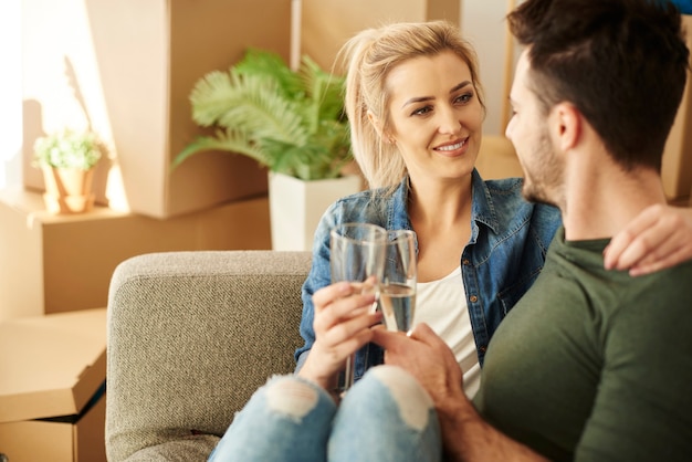 Couple chilling on the sofa with drinks