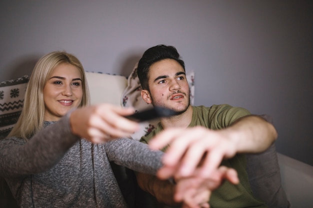 Free photo couple choosing channel on tv