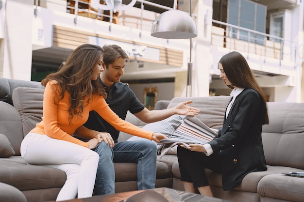 Free photo couple choosing fabric in furniture store