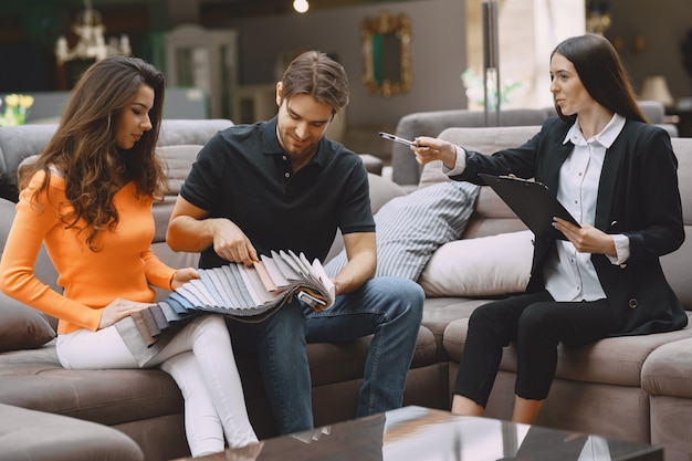 Couple choosing fabric in furniture store