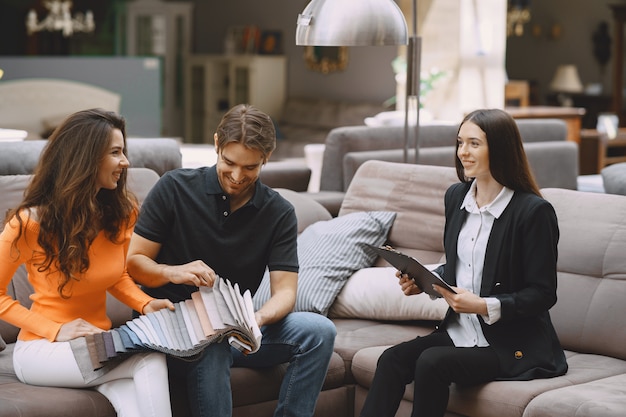 Couple choosing fabric in furniture store