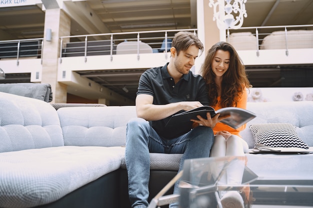 Couple choosing fabric in furniture store