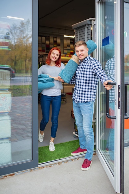 Free photo couple choosing textile at home decoration store