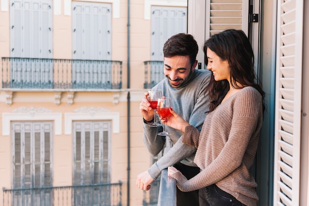 Couple clinking glasses on balcony