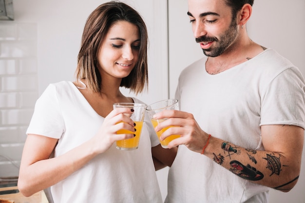 Couple clinking glasses with juice