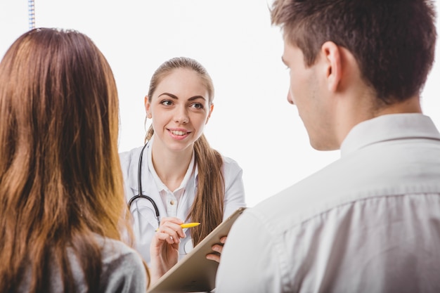 Couple consulting with young doctor