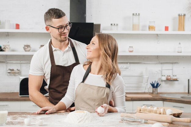 Couple cooking cake together