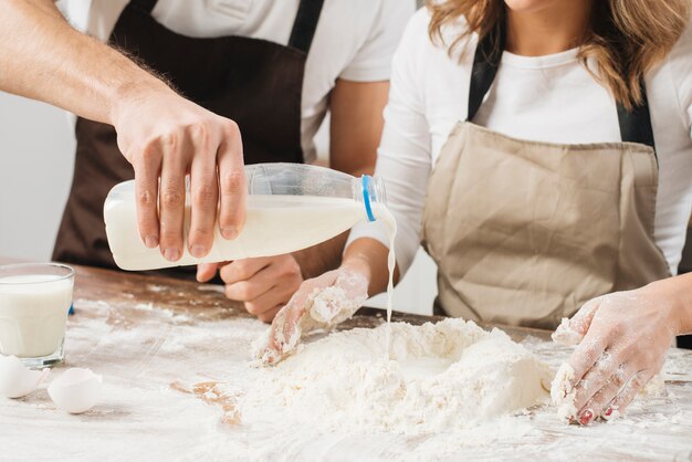 Couple cooking cake together