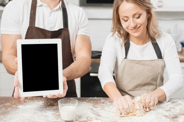 Couple cooking with tablet