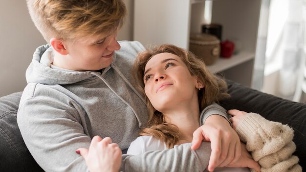 Couple on couch looking at each other