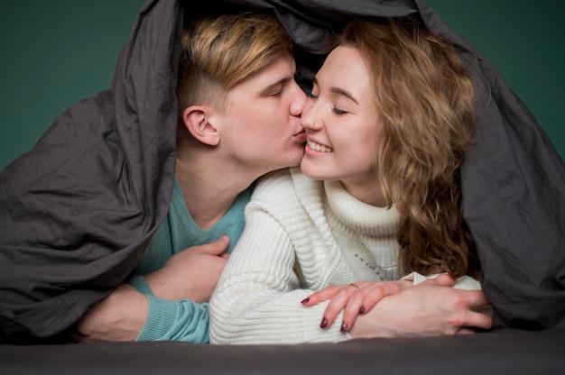 Free photo couple covered with blanket