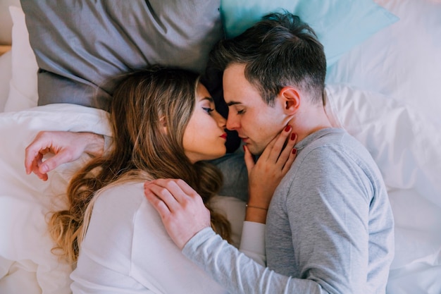 Free photo couple cuddling in bed