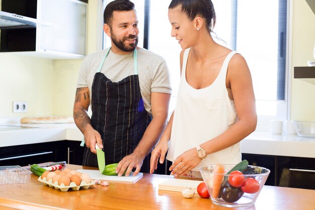 Couple cutting vegetable in kitchen