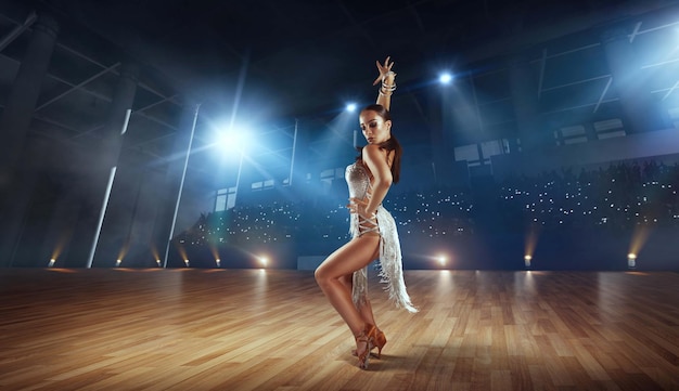 Free photo couple dancers perform latin dance on large professional stage ballroom dancing