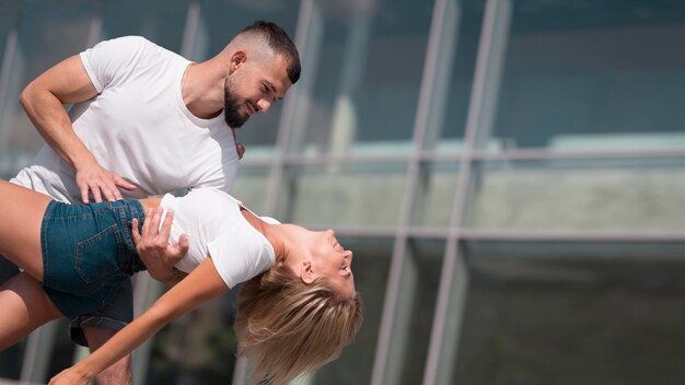 Couple dancing outside after coronavirus with copy space