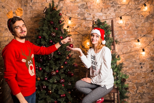 Couple decorating christmas tree