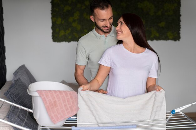 couple doing the laundry together at home