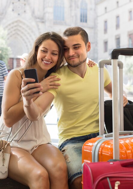 Couple doing selfie at the street