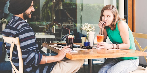 Couple drinking beverage at the cafe together