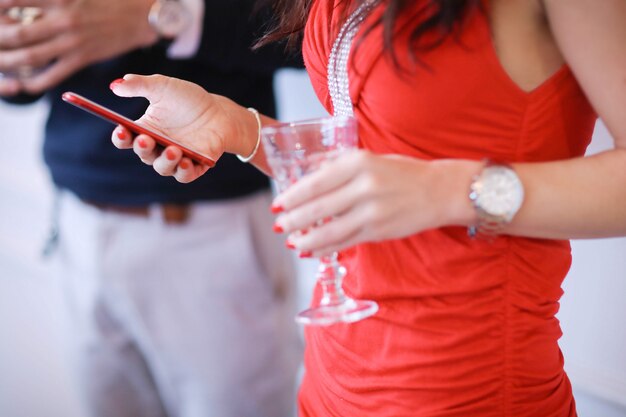 Couple drinking champagne and looking the smartphone