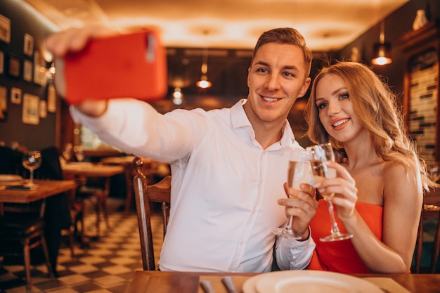 Пара пьет шампанское в ресторане на день Святого Валентина