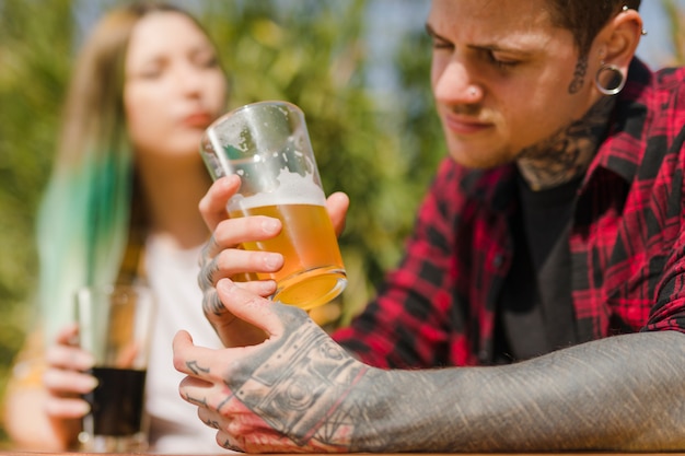 Couple drinking craft beer outdoors