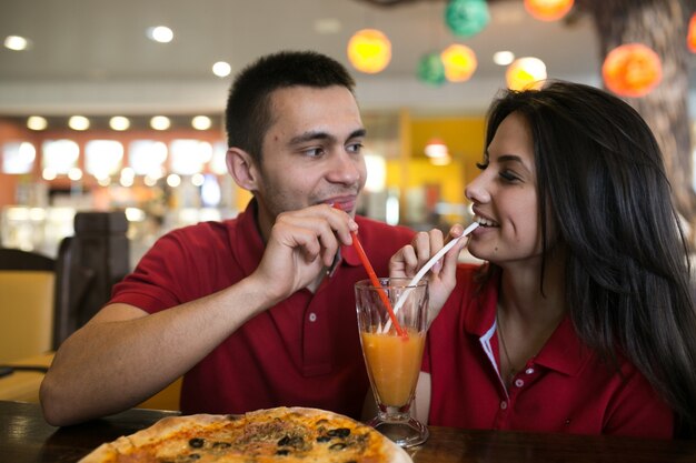 Couple drinking from one glass