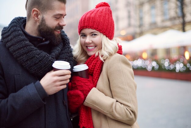 Couple drinking hot coffee outdoors