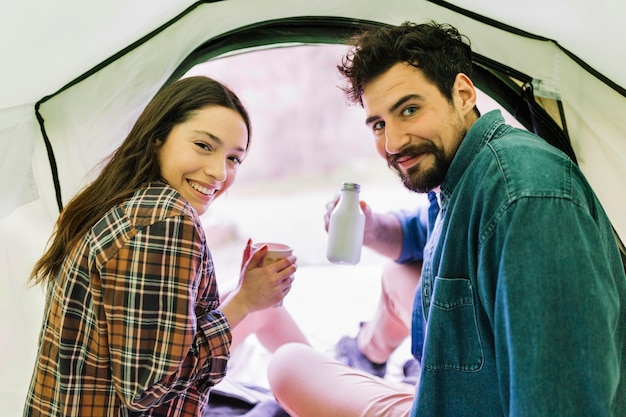 Couple drinking in tent