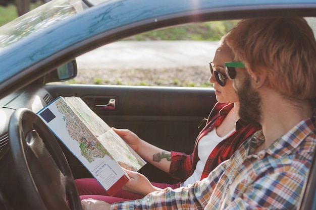 Couple driving and looking at map