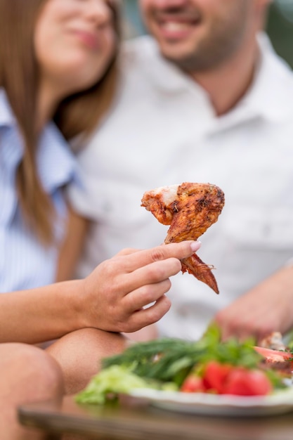 Couple eating barbecue outdoors