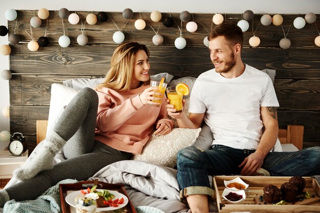 Couple eating breakfast in bed