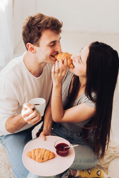 Couple eating croissant