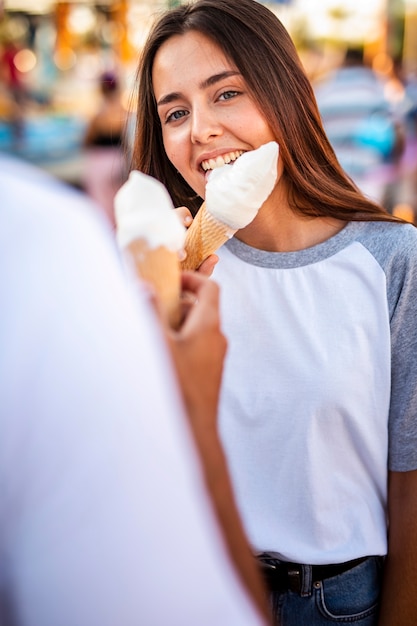 Foto gratuita coppie che mangiano i gelati alla fiera