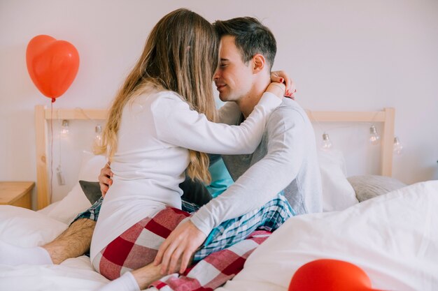Couple embracing on bed