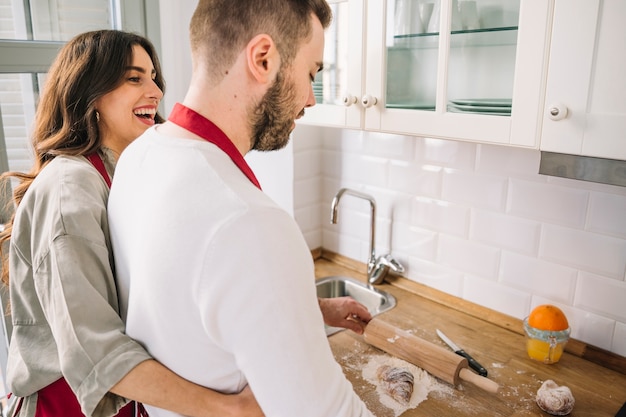 Couple embracing and cooking