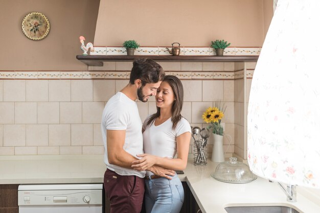 Couple embracing in kitchen