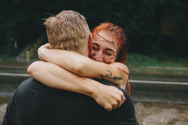 Couple embracing in the rain