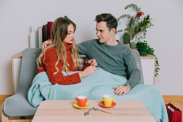 Couple embracing on sofa