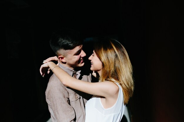 Couple embracing in sunny street