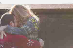 Free photo couple embracing at wall