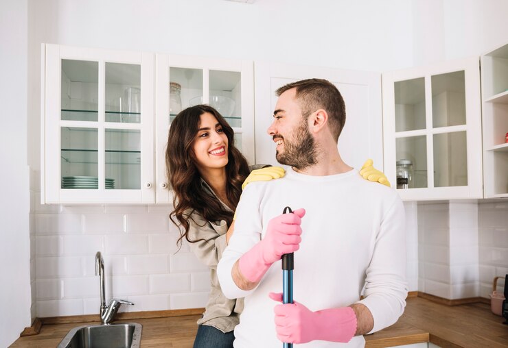 Free Photo couple embracing while cleaning