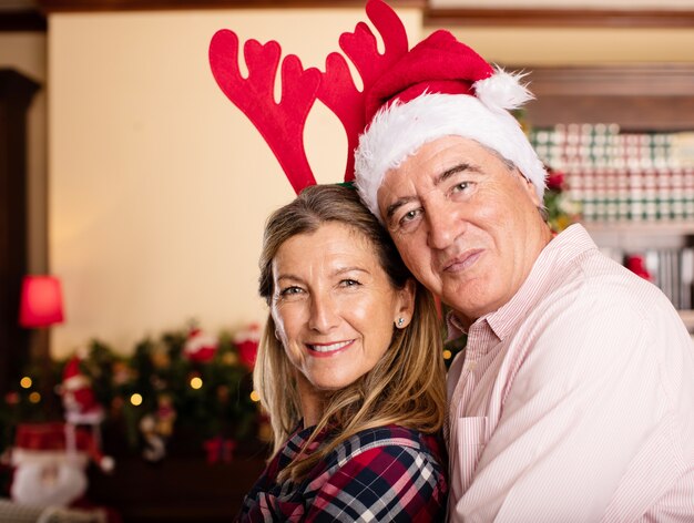 Couple embracing with christmas hats