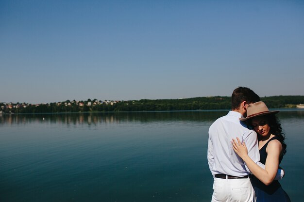 Couple embracing with lake background